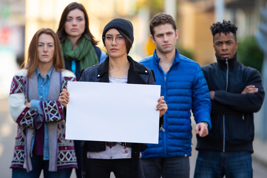 Group of protesters holding a blank sign during demonstration