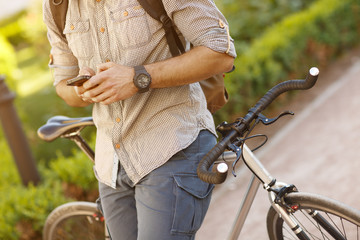 Young handsome bearded man using his smart phone