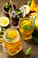 Summer drink set close-up. Refreshing summer berry Lemonade, lemon mint Tea and orange Lemonade with rosemary.