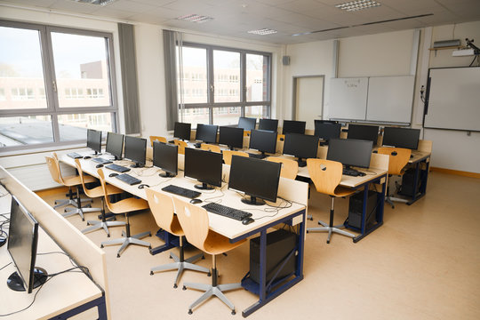 Computer classroom with monitors and keyboards for pupils and students in a school computer lab
