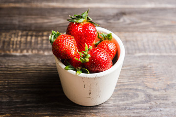 Fresh ripe strawberry on the dark rustic background. Selective focus. Shallow depth of field.