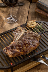 Grilled Striploin steak on grill on wooden table