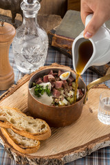Summer cold soup okroshka with radish, cucumber and beef on wooden board