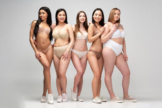 five pretty multicultural woman in lingerie posing at camera, body positivity concept