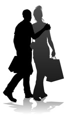 People silhouette of a young man and woman, probably a couple or husband and wife shopping holding retail bags