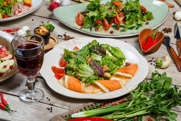 View from above of georgian cuisine on brown wooden table. Traditional georgian cuisine and food - khinkali, kharcho, chahokhbili, phali, lobio and local sauces - tkemali, satsebeli, adzhika. Top view