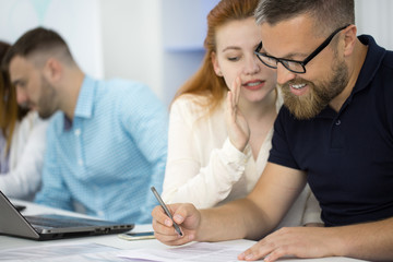 Fototapeta premium Businessman working with his female colleague