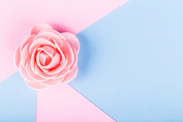 artificial rose on a colored background, image with place for text