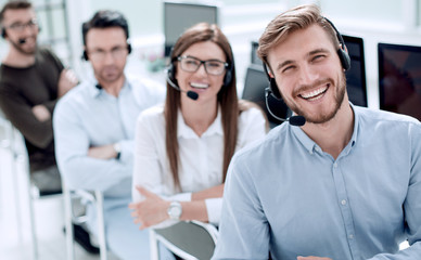rear view.employees of the call center looking at the camera
