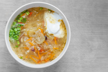 vegetarian soup of sauerkraut with green onions and sour cream