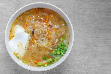 vegetarian soup of sauerkraut with green onions and sour cream