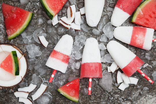 Homemade watermelon coconut ice lollies on crushed ice