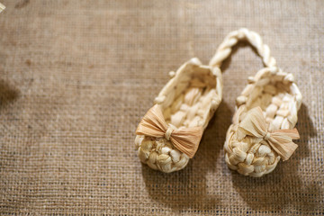 Fototapeta na wymiar Traditional vintage shoes woven from straw, souvenir