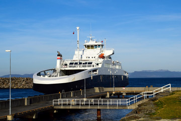 Ferry against the blue sea and sky near the port. Sea transport. Norway