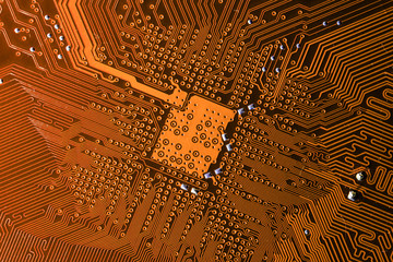Close up photo of orange pcb printecd circuit board electric paths