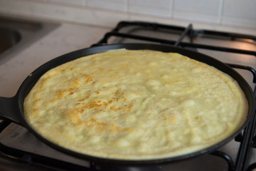 Making fresh homemade thin crepes pancakes