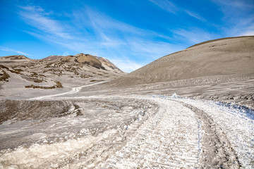 Footpath to Etna Volcano with smoke in winter, volcano landscape, Sicily island, Italy