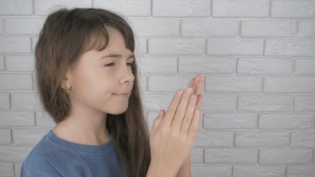 Exercise to relax the eyes. Cute little girl makes eye palming.