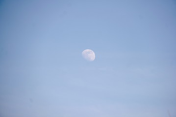 The moon in the daytime sky blue 