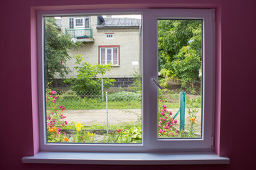 summer outside the window,grow flowers outside the window in the rural settlement