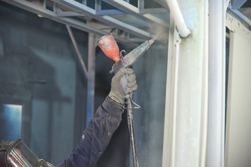 A man produces powder paint metal products.