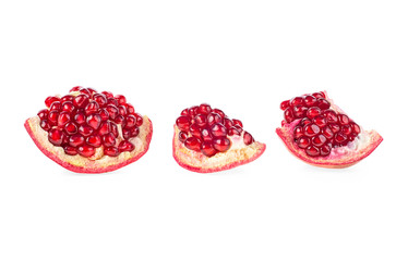Pomegranate pieces with juicy grains isolated on white background