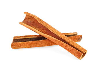 Two aromatic cinnamon sticks on a white background