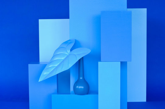 Various cuboids, blue vase with blue leave