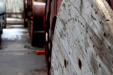 Wooden and metal industrial cable reels in the factory outside