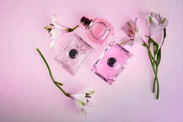 perfume bottles surrounded by flower top view