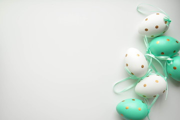 Easter eggs are white blue polka dots. Festive mood. Easter attributes. Drawing on the eggs. White...