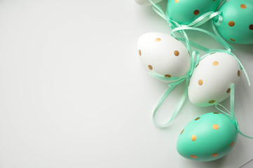 Easter eggs are white blue polka dots. Festive mood. Easter attributes. Drawing on the eggs. White background