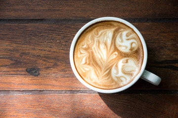 Top view cafe latte, Close up hot cappuccino coffee cup on table.