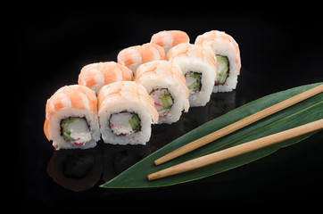 sushi roll with shrimp on black background