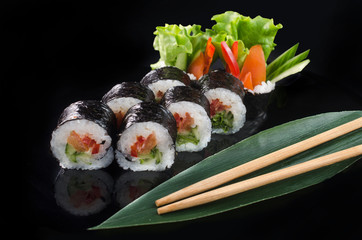 vegan sushi rolls on black background