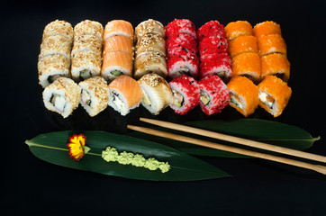 sushi set with different rolls isolated on black