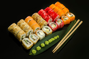 sushi set with different rolls isolated on black