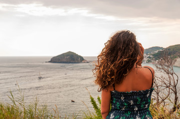 closeup of beautiful girl posing with panoramic view of Ischia