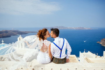 Bride and groom  kiss on the background of the sea