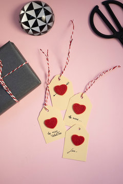 Valentine gift, paperweight, self-made tags and scissors on pink background