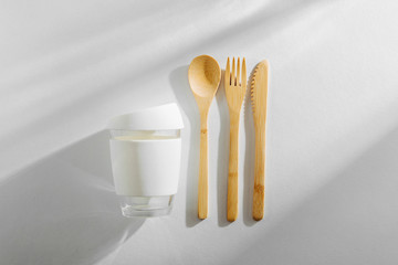 Eco friendly bamboo cutlery set and reusable coffee mug. Zero waste, plastic free concept.