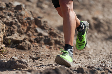 Trail running action close up of running shoes in action