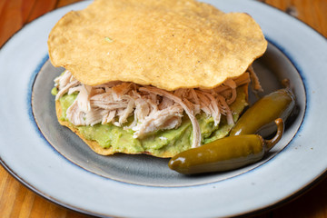 Mexican food. Tortilla toast with chicken and guacamole 