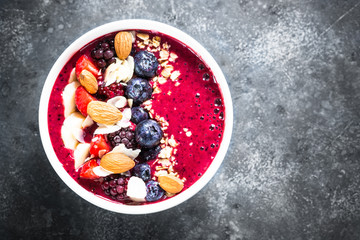 Smoothie bowl from fresh berries, nuts and granola.