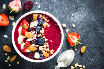 Smoothie bowl from fresh berries, nuts and granola.