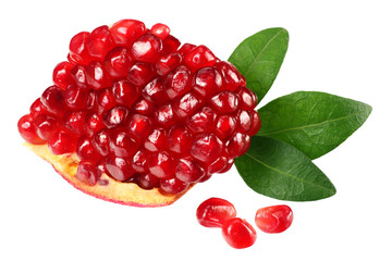 pomegranate seeds with green leaves isolated on white background