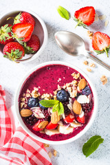 Smoothie bowl from fresh berries, nuts and granola.