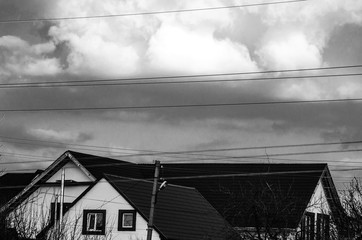Black and white photo of the sky with clouds above the building
