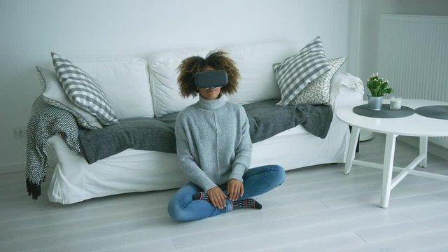 Woman in VR glasses at home