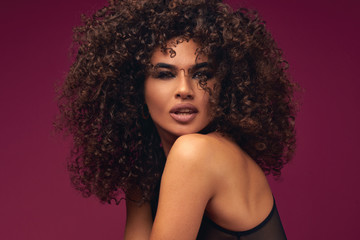 portrait of curly model on bright background